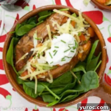 What to Serve with Carnitas: 25 Irresistible Recipes 18 A Mexican Stuffed Sweet Potato served on a bed of lettuce in a brown bowl.
