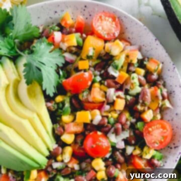What to Serve with Carnitas: 25 Irresistible Recipes 27 Colorful Fiesta Salad served in a white bowl.
