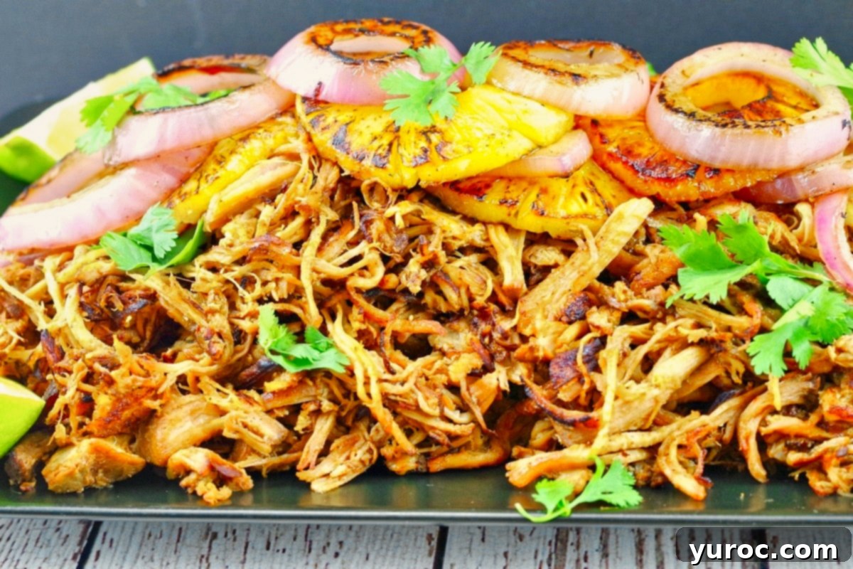 What to Serve with Carnitas: 25 Irresistible Recipes 29 A large tray of pineapple carnitas, freshly cooked and ready to be served.