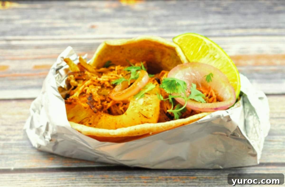 What to Serve with Carnitas: 25 Irresistible Recipes 30 Pork pineapple carnitas wrapped in aluminum foil, ready to be kept warm or served.