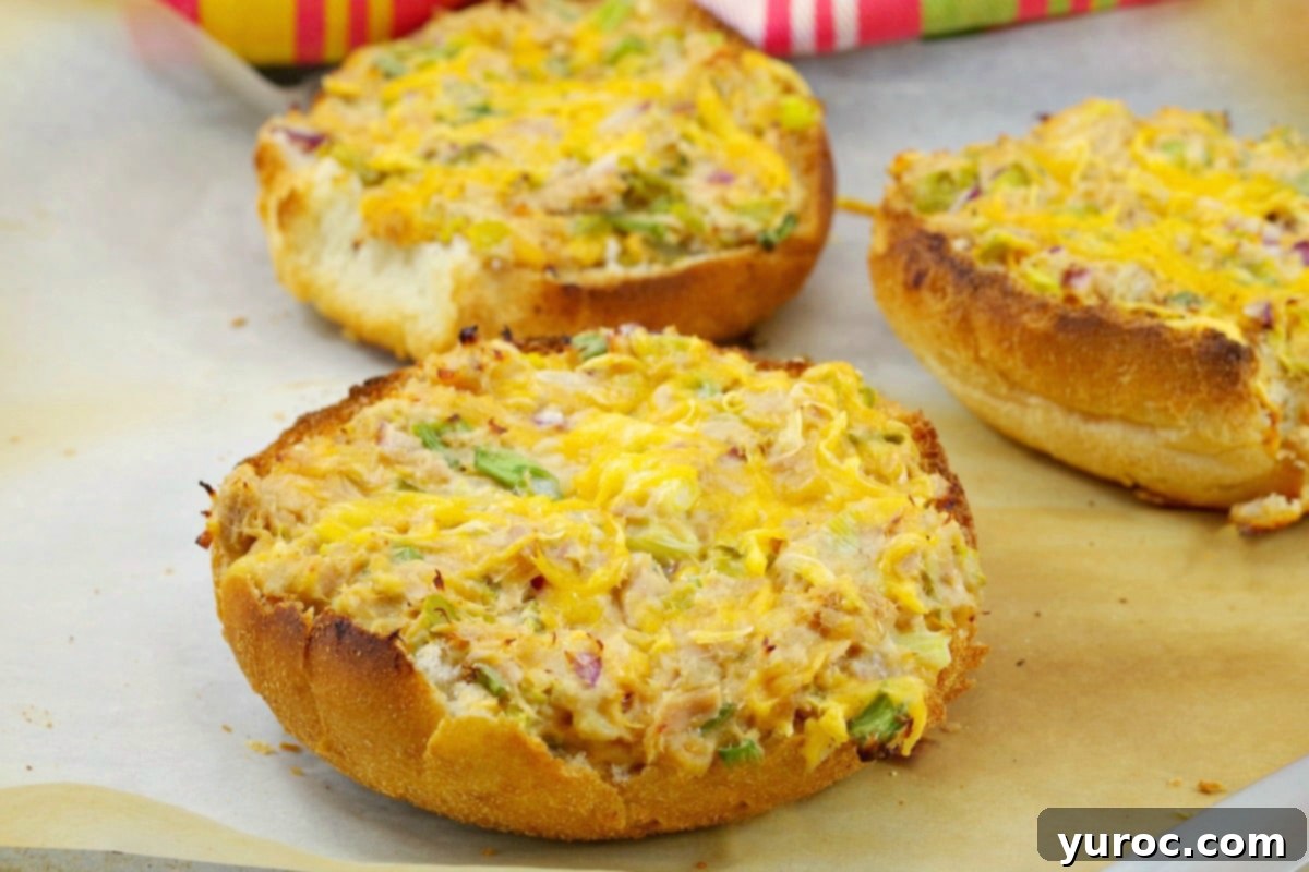 Creamy Tuna Dip 9 Open-faced tuna melts, topped with melted cheese, arranged on parchment paper on a baking sheet.