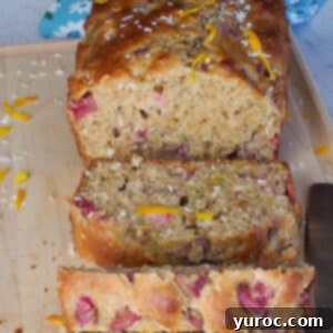 healthy rhubarb bread on a cutting board with 3 pieces sliced