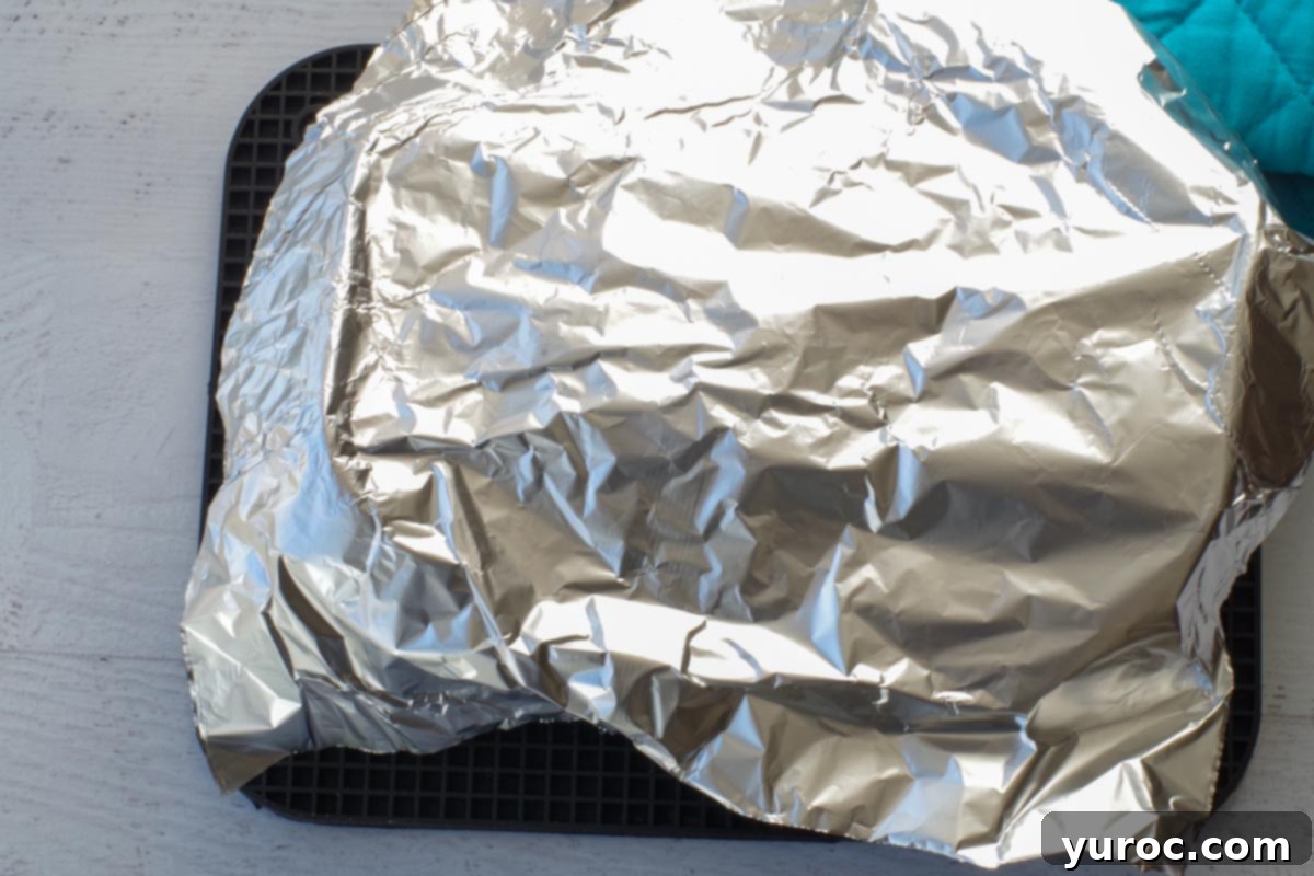 aluminum foil placed loosely over the top of the bread