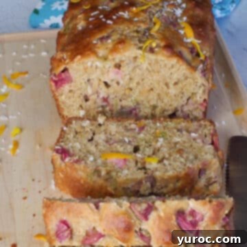healthy rhubarb bread on a cutting board with 3 pieces sliced