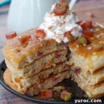 4 stacked rhubarb pancakes with piece cut out of middle