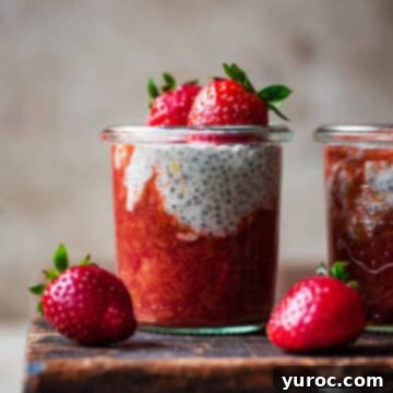 rhubarb chia pudding in glasses with strawberries on a wood surface