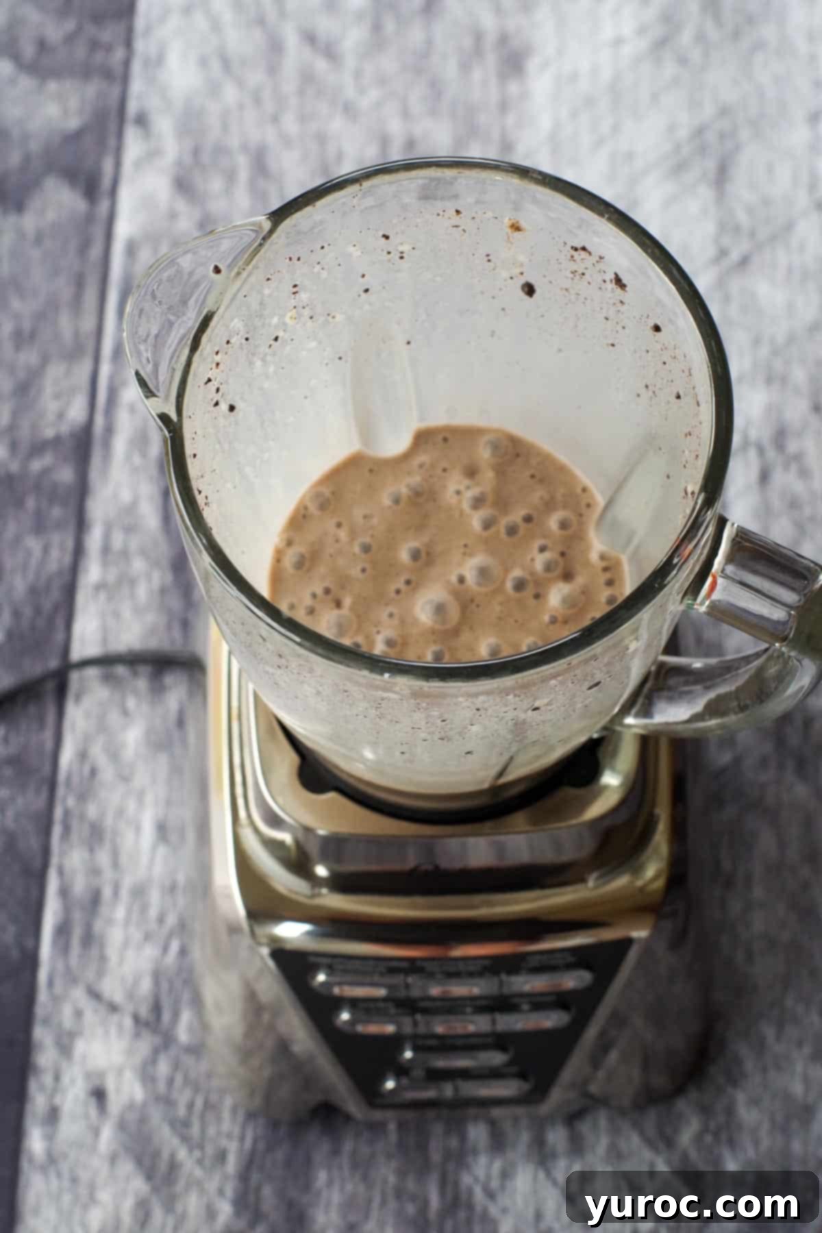 Guilt-Free Oreo Banana Milkshake 5 The blended Oreo banana milkshake, showing a smooth, creamy texture, poured into a glass.