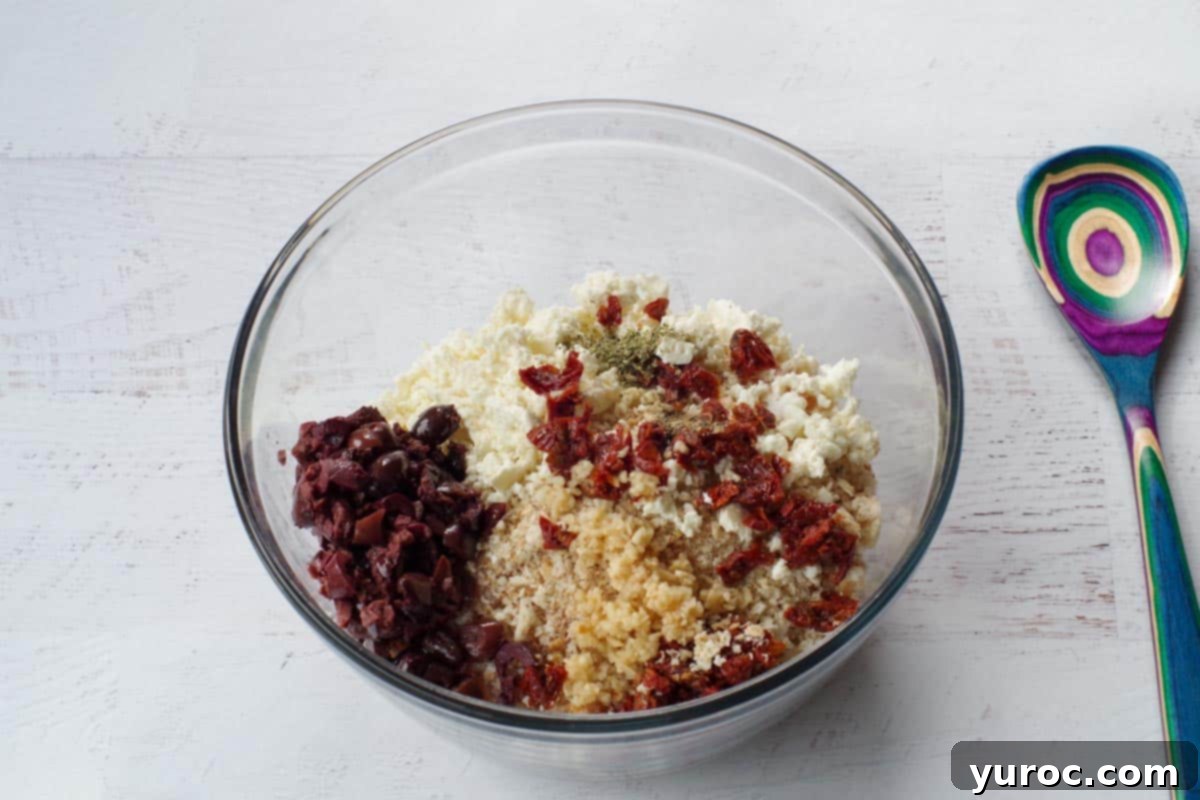 ingredients for Greek chicken burger in a large glass bowl