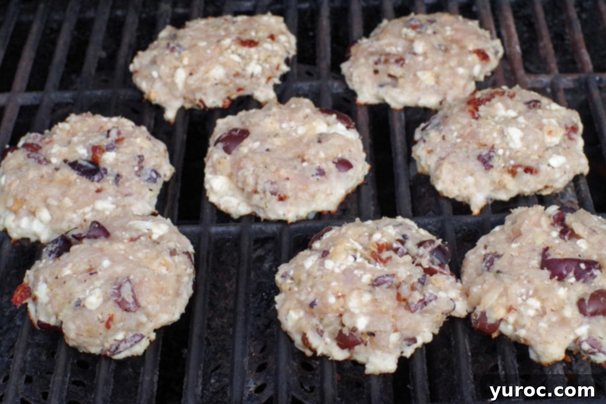 Greek chicken burger patties on grill