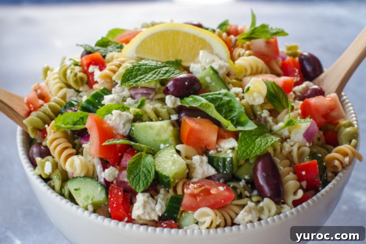 Greek pasta salad in white bowl