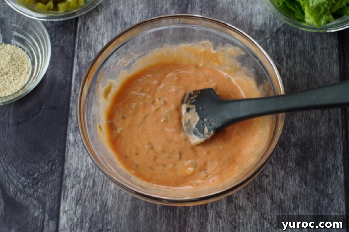 Pizza sauce ingredients in a medium glass bowl, with a spatula