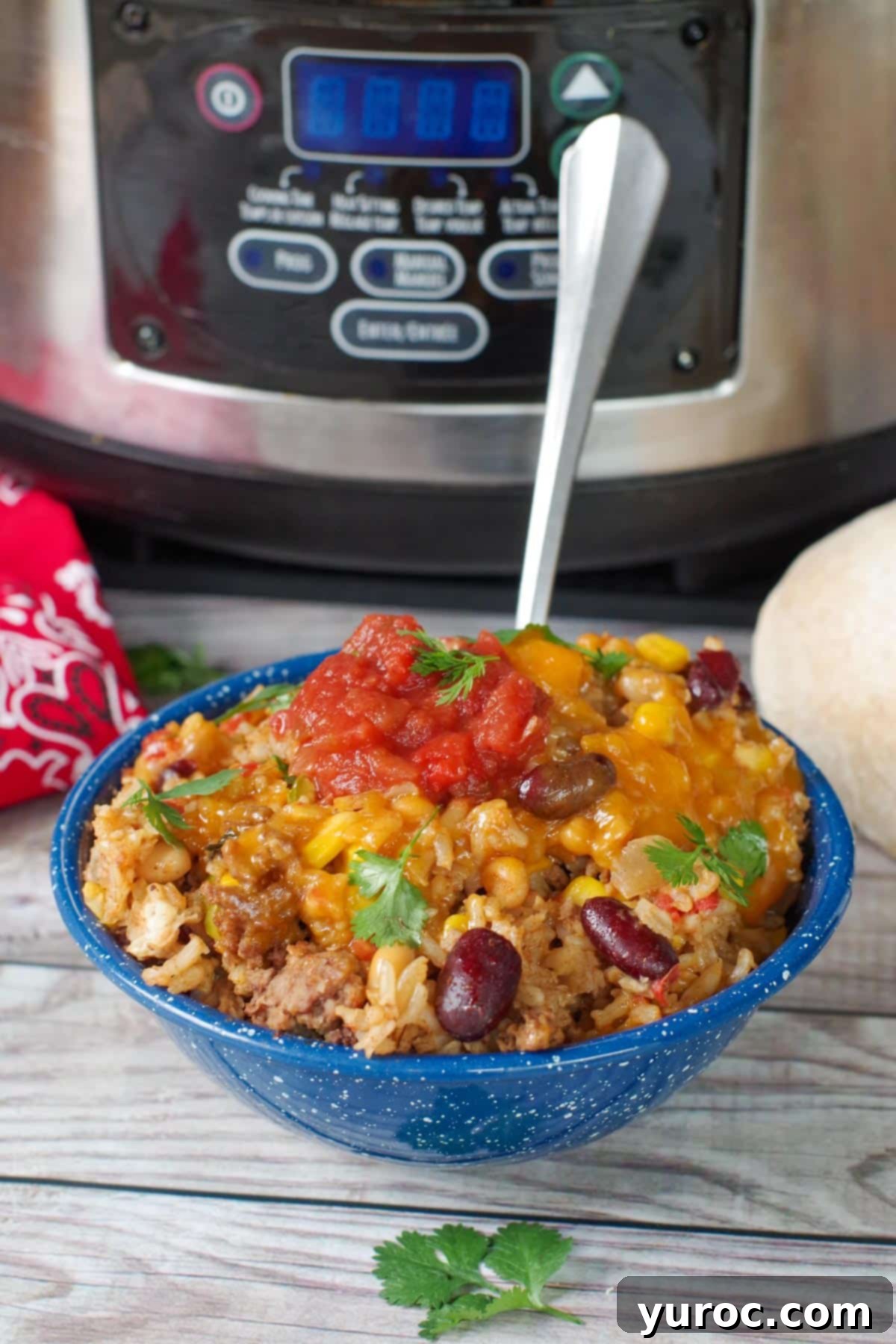 a bowl of cowboy casserole in front of a crock pot