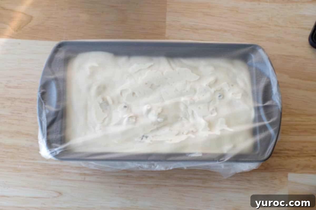 Effortless Butter Tart Dream Ice Cream 14 Butter tart ice cream mixture poured into a loaf pan and covered tightly with Glad Press n' Seal, ready for freezing.