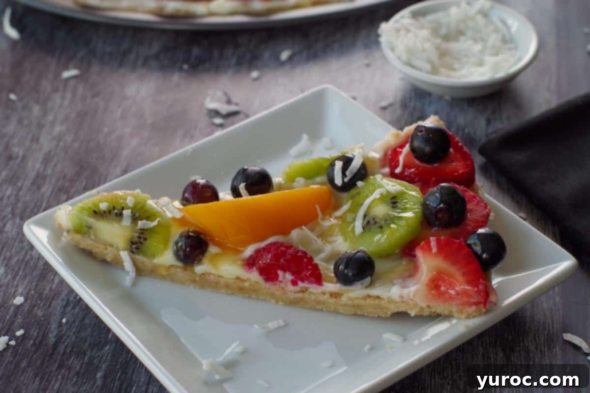 Vibrant Fruit Pizza with Sweet Glaze 16 A single slice of fruit pizza, perfectly plated on a white dish, showcasing its vibrant layers and inviting appeal.