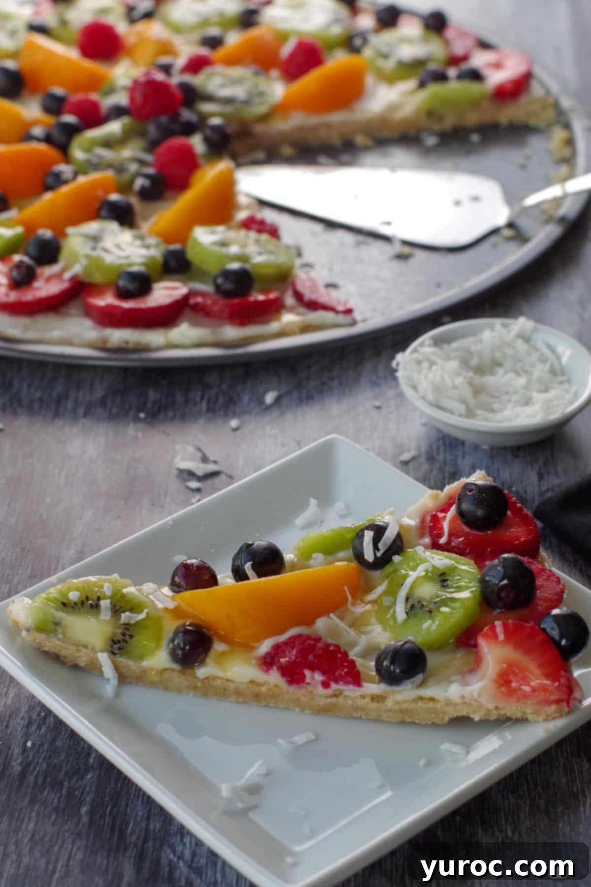 Vibrant Fruit Pizza with Sweet Glaze 18 A perfectly portioned slice of fruit pizza, highlighting its fresh fruit, creamy layer, and golden crust, served on a pristine white plate.