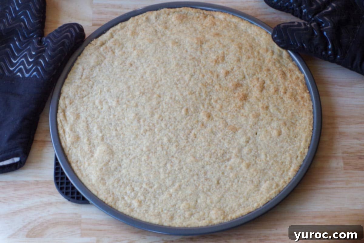 Vibrant Fruit Pizza with Sweet Glaze 7 The freshly baked shortbread crust, golden brown and perfectly set on the pizza pan, awaiting its creamy topping.