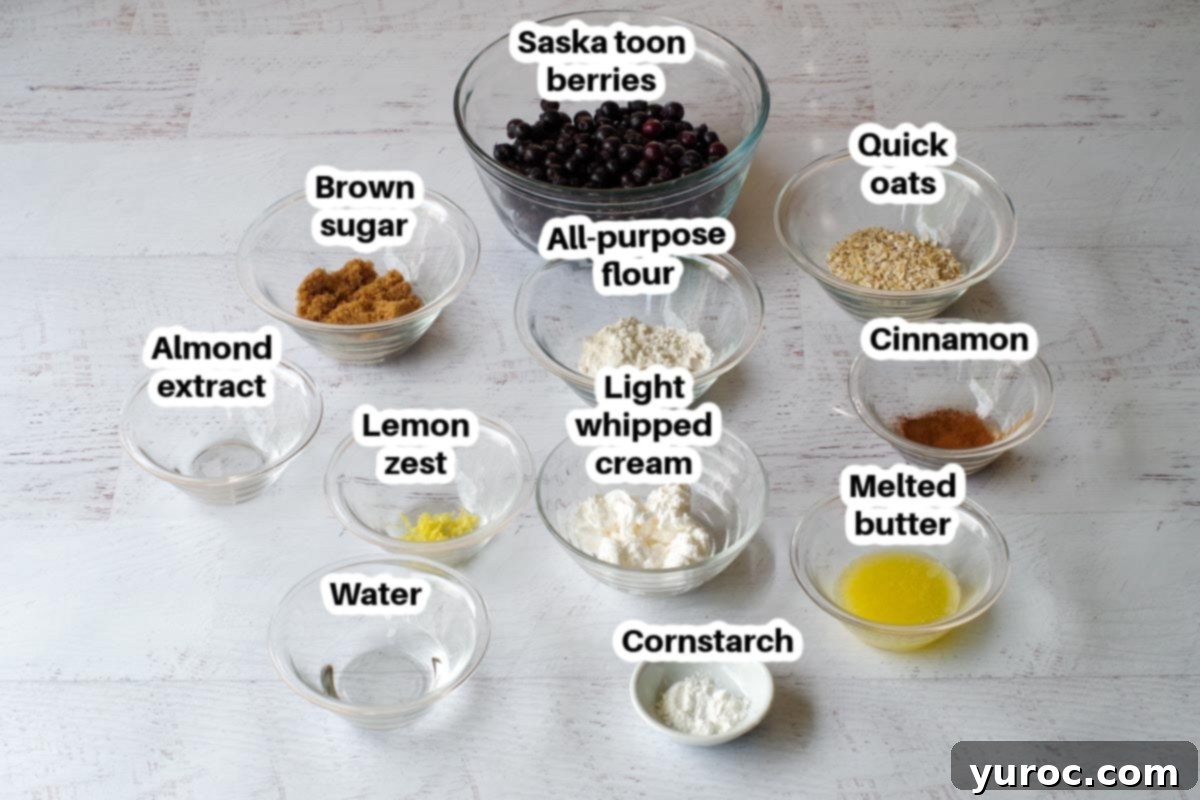 Saskatoon Berry Crisp in a mug ingredients in glass dishes on faux wooden surface, labelled