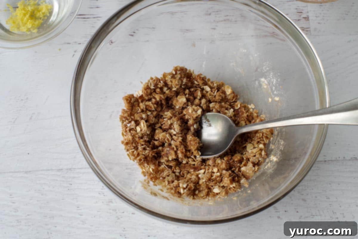 crisp topping stirred together in glass bowl, with spoon