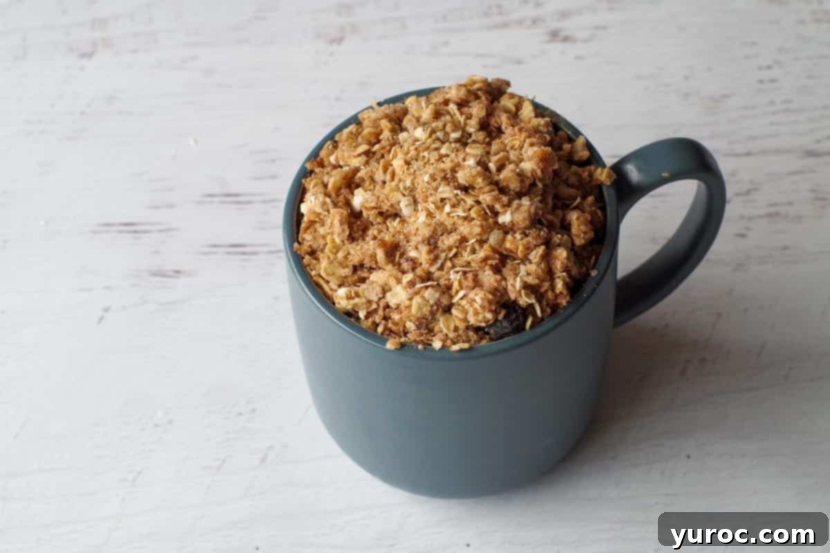 Saskatoon berry crisp in blue mug ready for the microwave