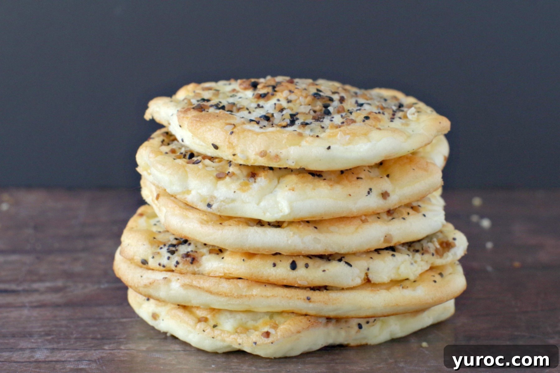 Six slices of fluffy Everything Bagel Cloud Bread, artfully stacked, showcasing their light texture and savory seasoning