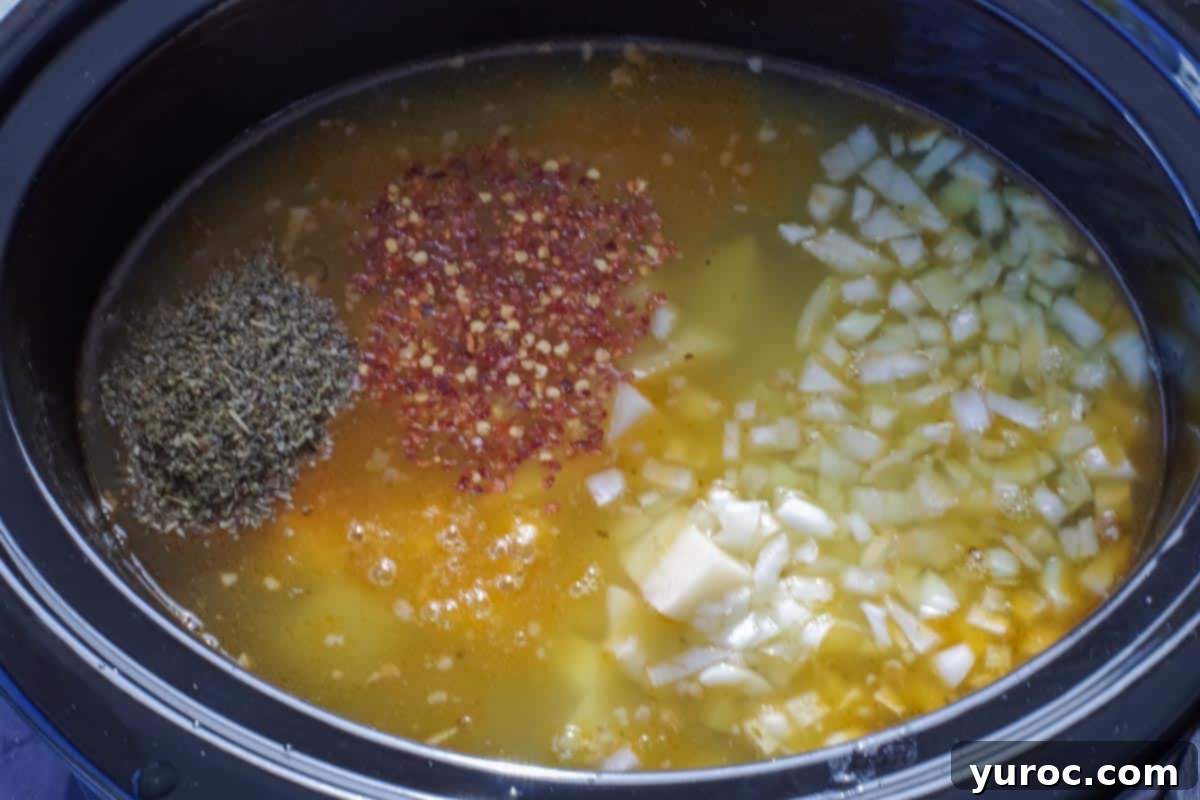 turkey sausage, chicken broth, onions, Italian seasoning, red pepper flakes and potatoes added to a slow cooker