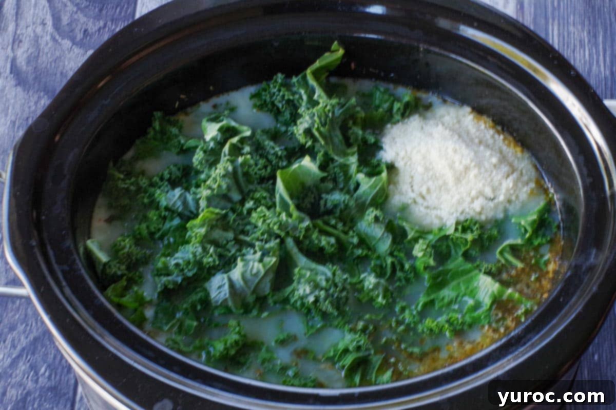 kale, parmesan cheese, milk and potato flakes (or instant mashed potatoes) added to soup in slow cooker