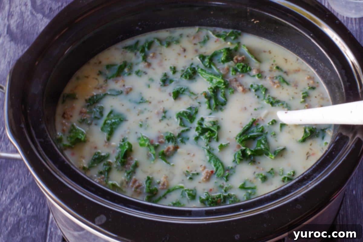 zuppa toscana in slow cooker cooking on high for 10 minutes until thickened