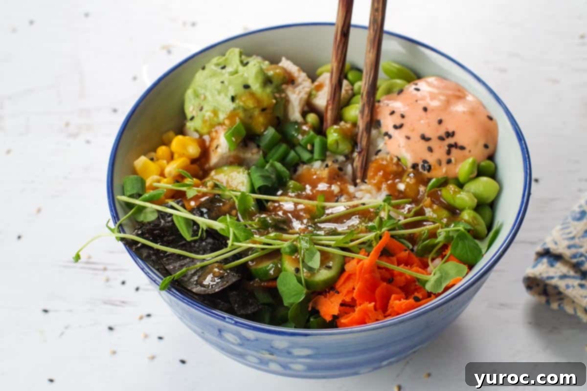 The chicken poke bowl, now complete with microgreens, a generous drizzle of various sauces, and a sprinkle of sesame seeds, presented with chopsticks.