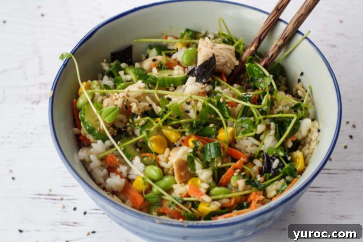 A fully mixed chicken poke bowl, showcasing all ingredients combined, ready to be enjoyed.