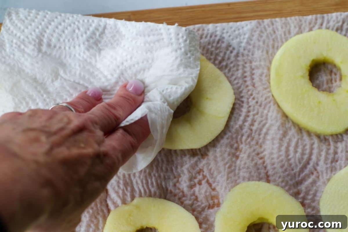 apples being patted dry with paper towel