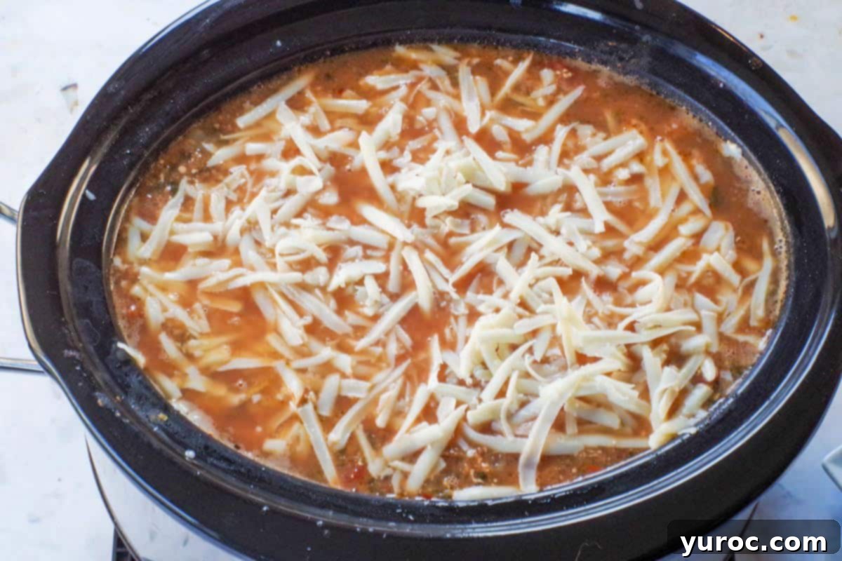 Melted mozzarella cheese stirred into the hot slow cooker lasagna soup