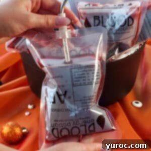 Virgin Blood Bags Halloween 10 Halloween blood bag with a straw in it and more blood bags in a cauldron in the background