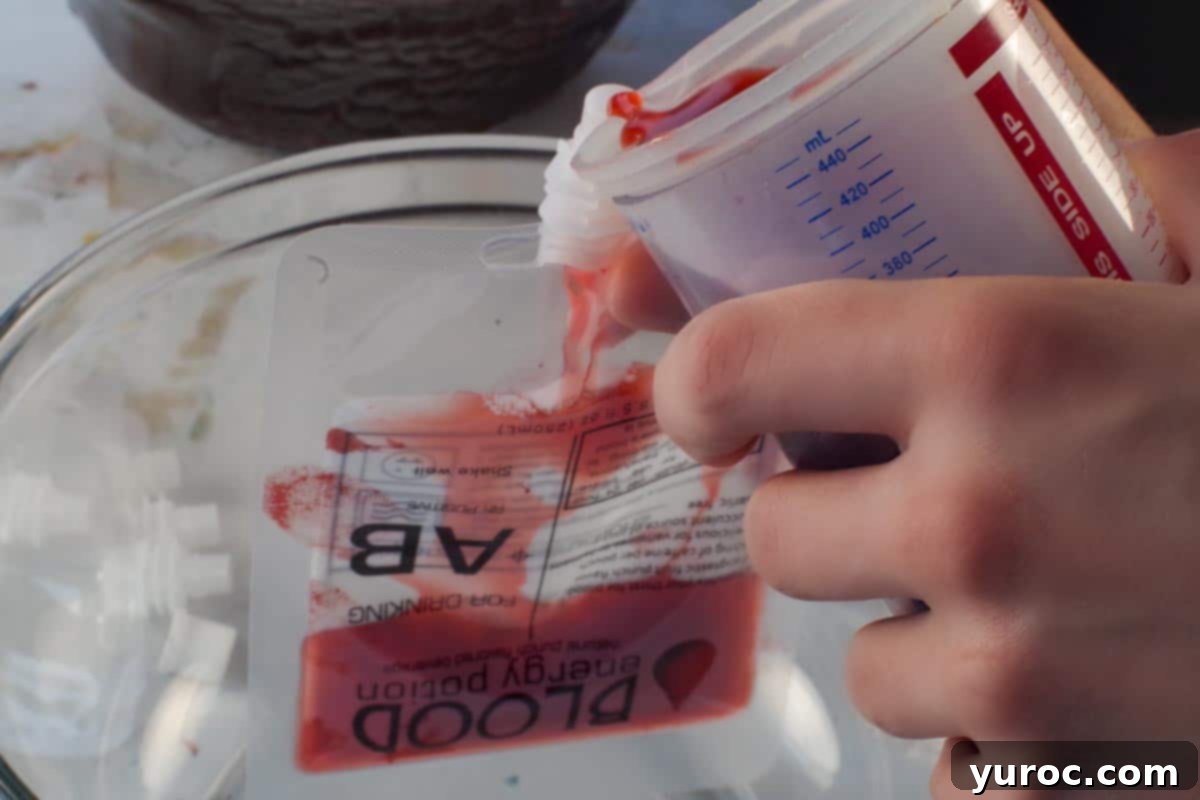 Virgin Blood Bags Halloween 5 Pouring the crimson punch into a plastic blood bag, carefully positioned over a large bowl to catch any potential spills.