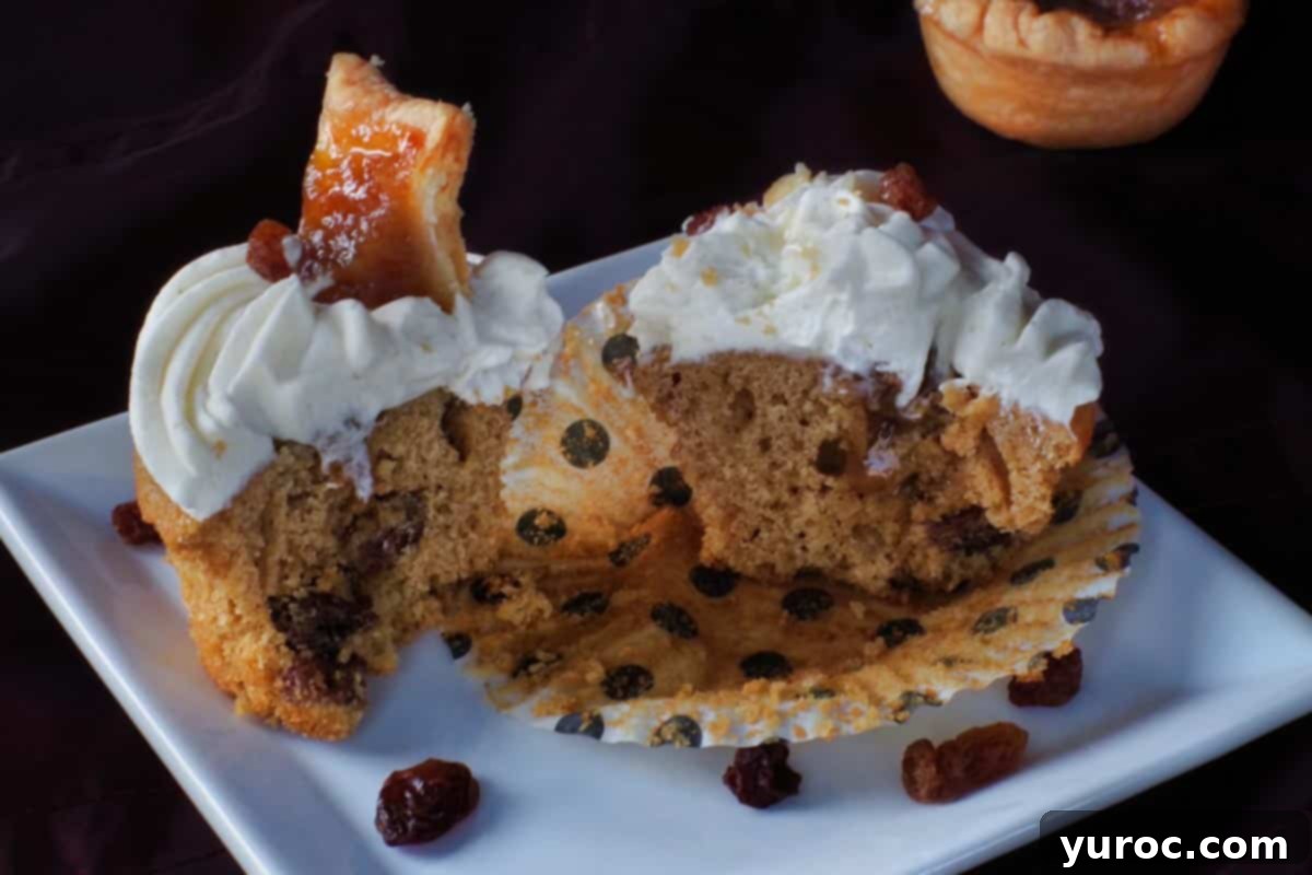 A butter tart cupcake split in half, revealing the gooey filling inside