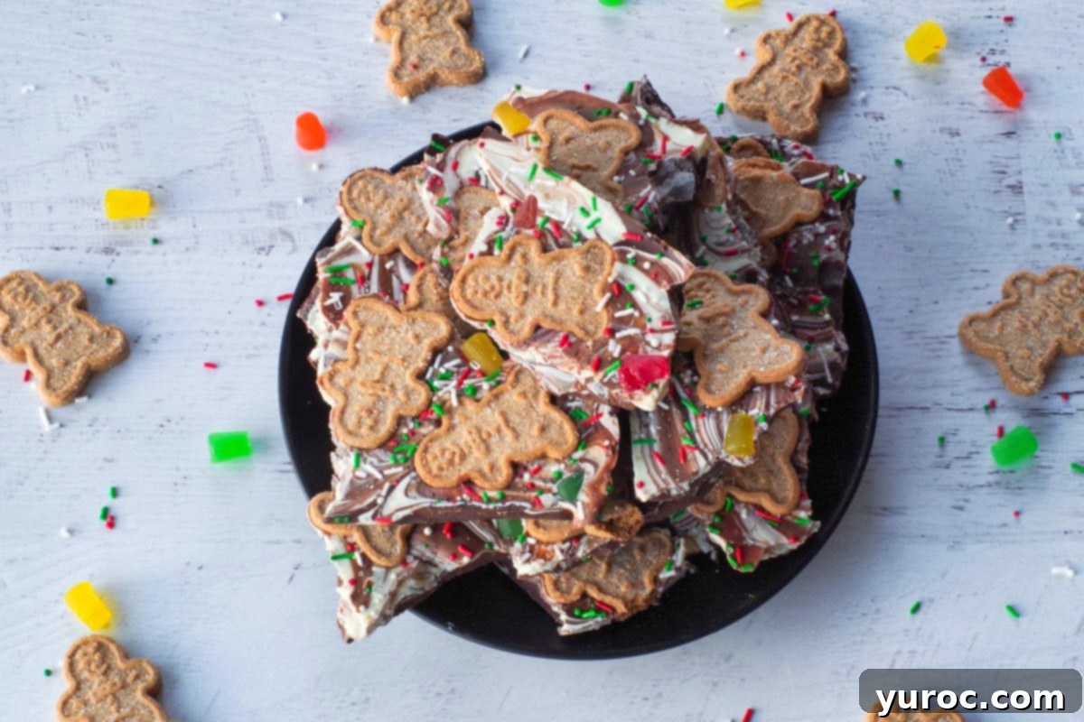 Christmas chocolate bark on a plate with mini gingerbread men cookies around it