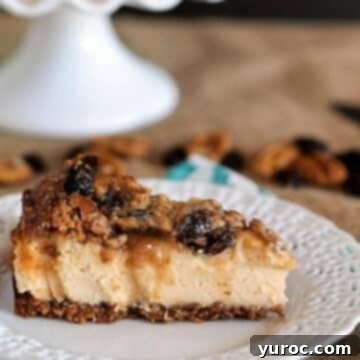 A stunning gluten-free maple butter tart cheesecake beautifully plated on a white dish, with a matching white cake stand gently blurred in the background
