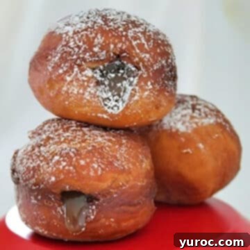 Three decadent Butter Tart Donuts artfully arranged on a vibrant red platter, showcasing their rich filling and inviting texture