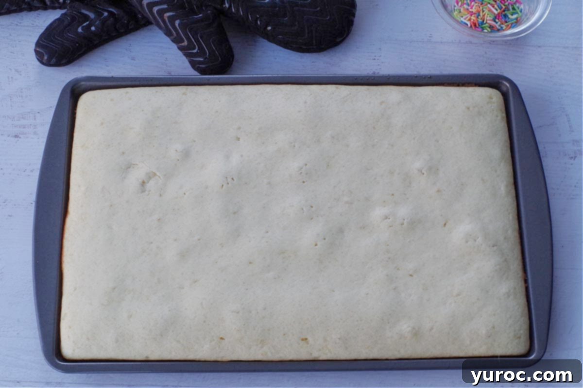 cooked sheet pan pancakes with oven mitts in the background