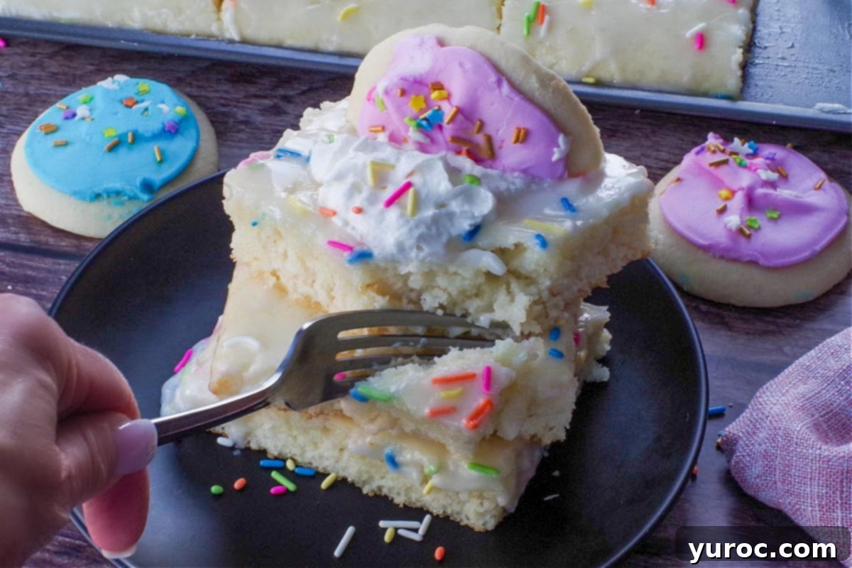 a stack of 3 sugar cookie sheet pan pancakes on a black plate, being sliced into with a fork