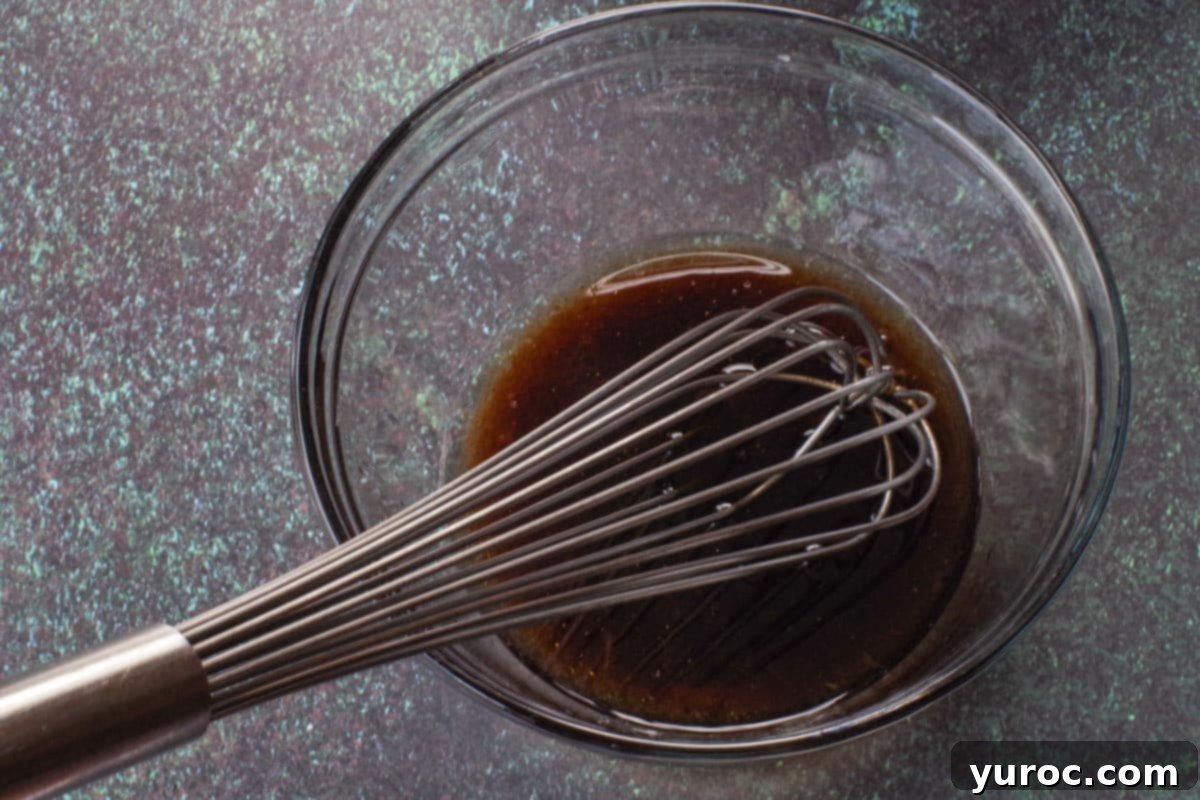 salad dressing ingredients whisked together in medium glass bowl