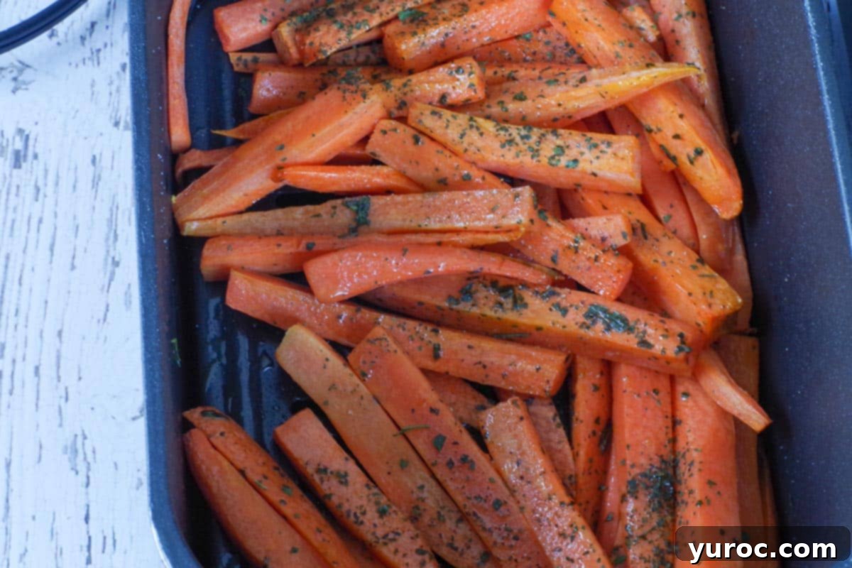 partially cooked carrot fries in air fryer drawer