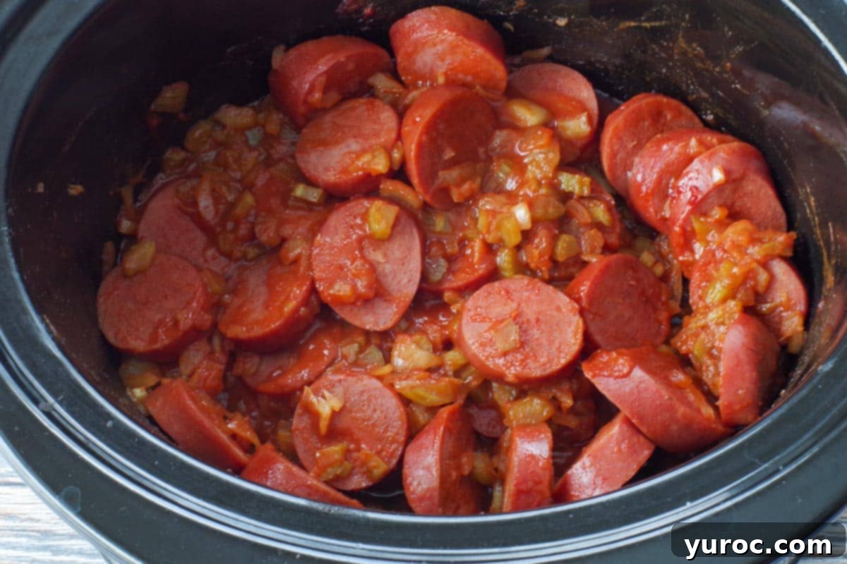 Cooked kielbasa appetizer simmering in the slow cooker, ready to serve