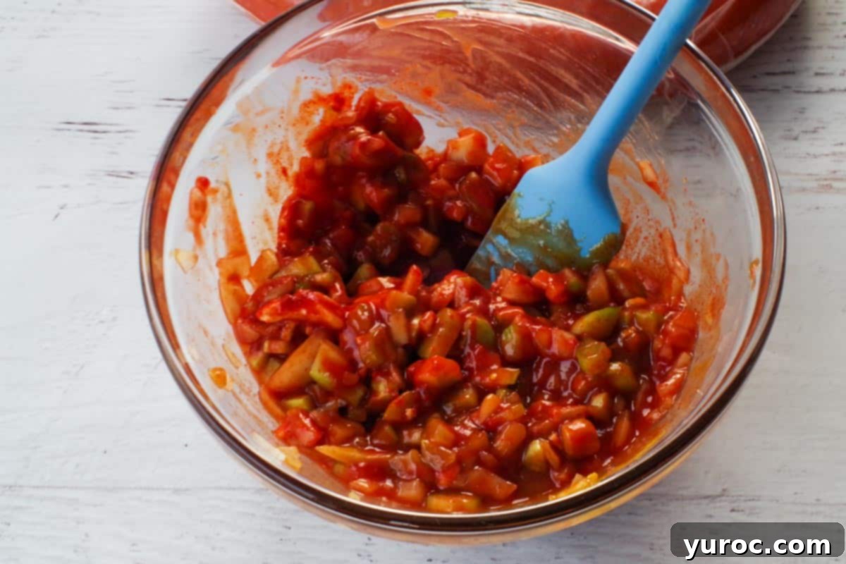 Remaining sauce ingredients mixed together in a glass bowl, stirred with a blue spatula