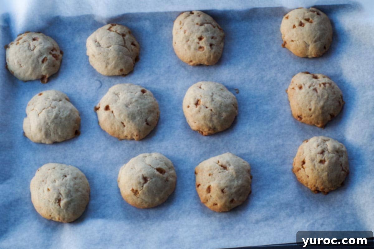 cooked eggnog and baileys cookies on parchment lined baking sheet