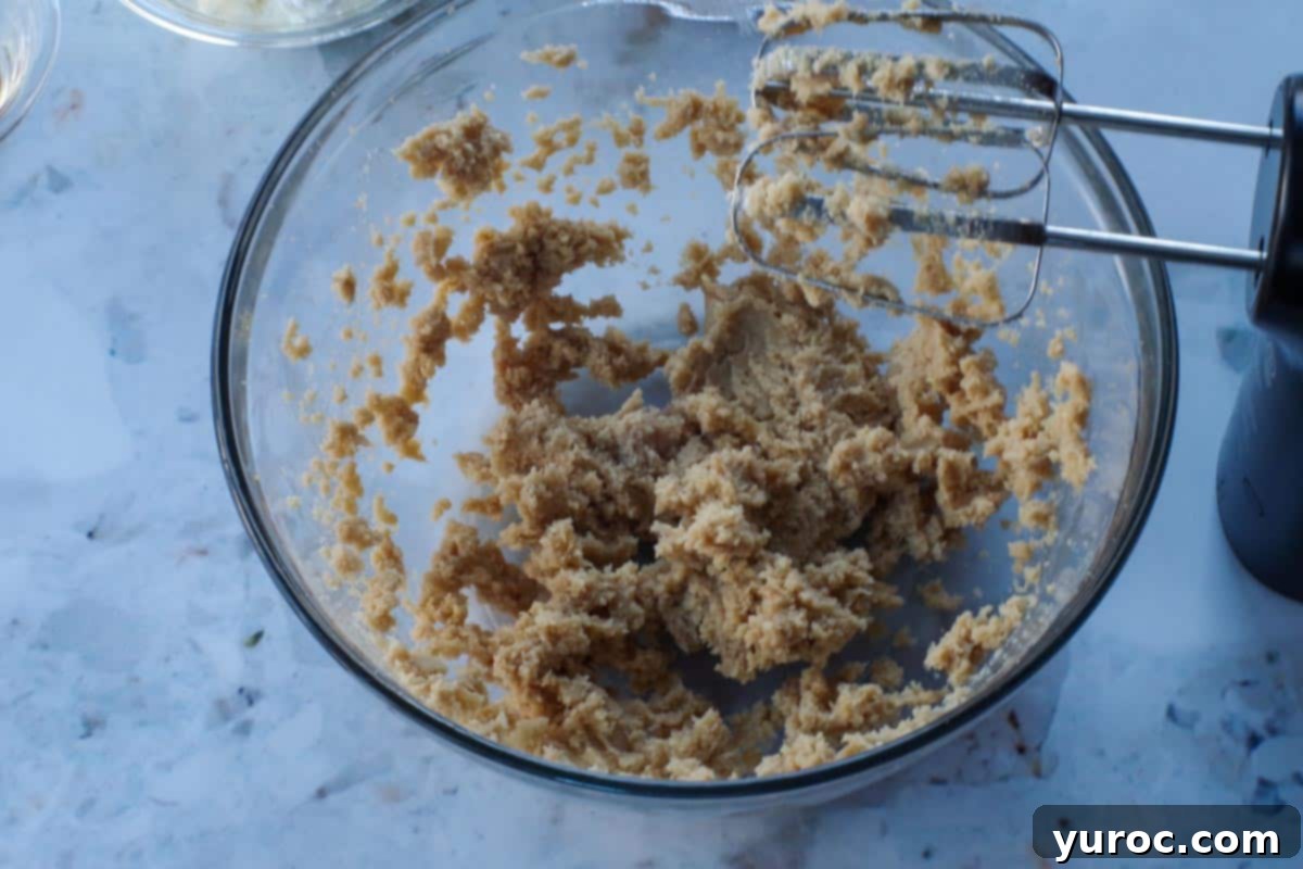 butter and sugar creamed together in glass bowl with beaters
