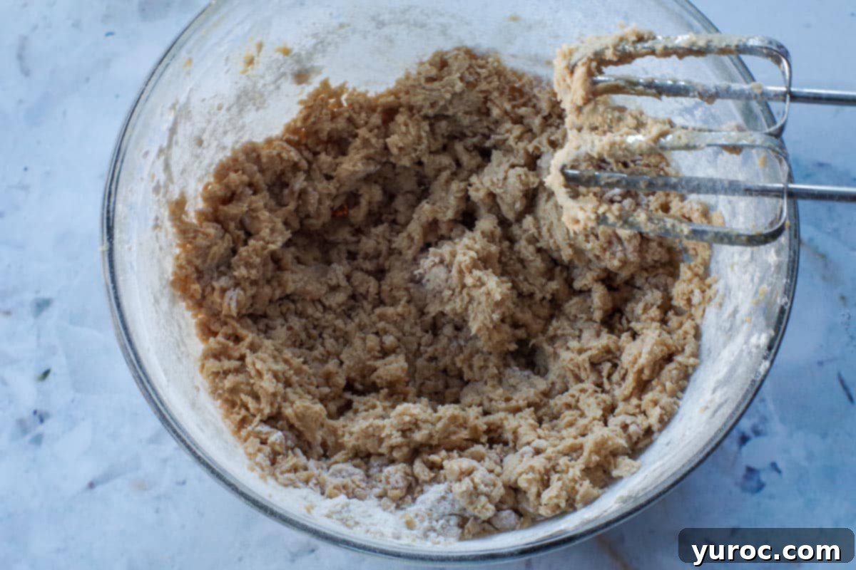flour mixture added to wet mixture in glass bowl with beaters.