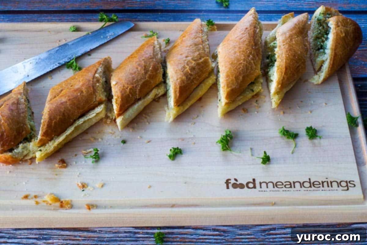 A beautifully arranged loaf of baguette garlic bread slices presented on a customized wooden cutting board, highlighting the perfect golden crust and inviting texture.