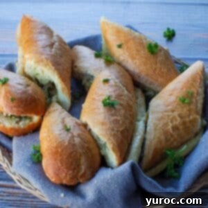 sliced baguette garlic bread in a small basket with a grey liner