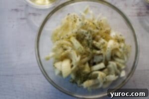onion sprinkled with half the parsley and garlic powder in a glass bowl
