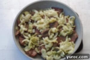 onions added to skillet with venison